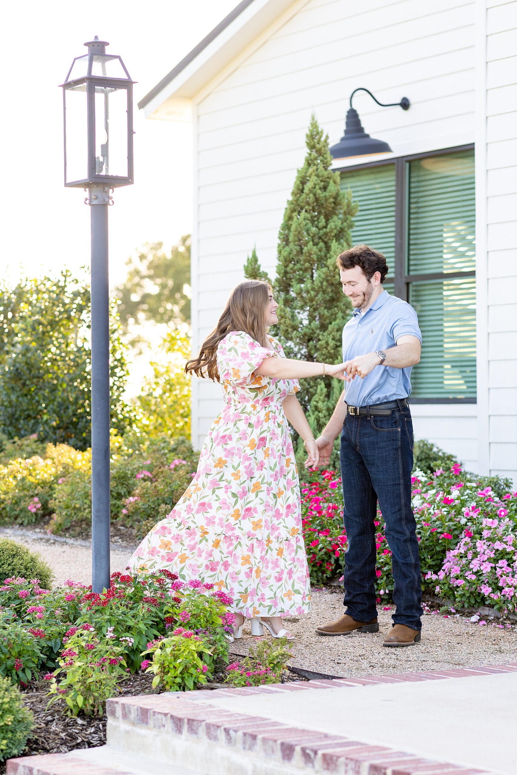 candid engagement portraits of couple twirling and laughing
