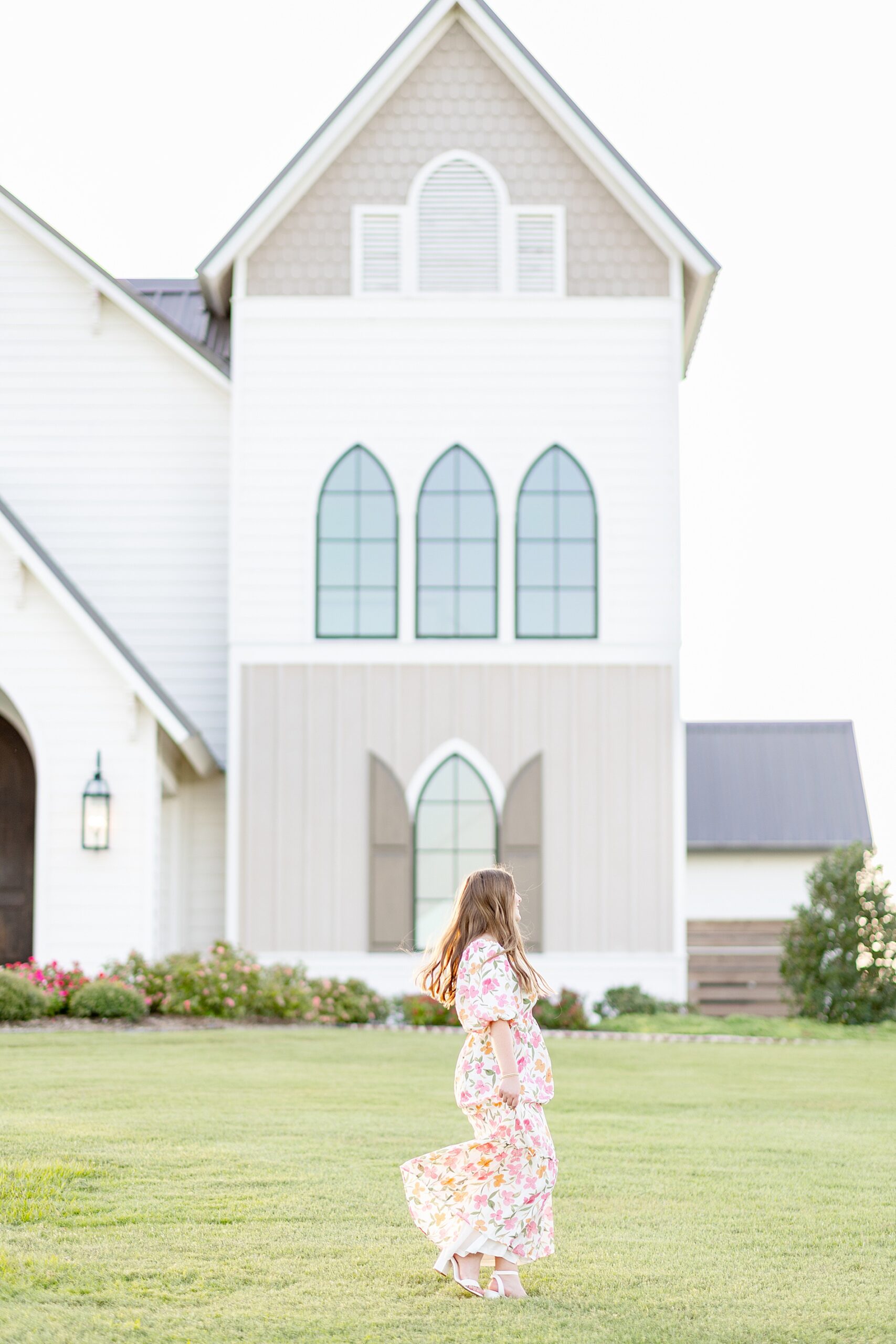 woman twirls in her floral dress from Deep In The Heart Farms Engagement