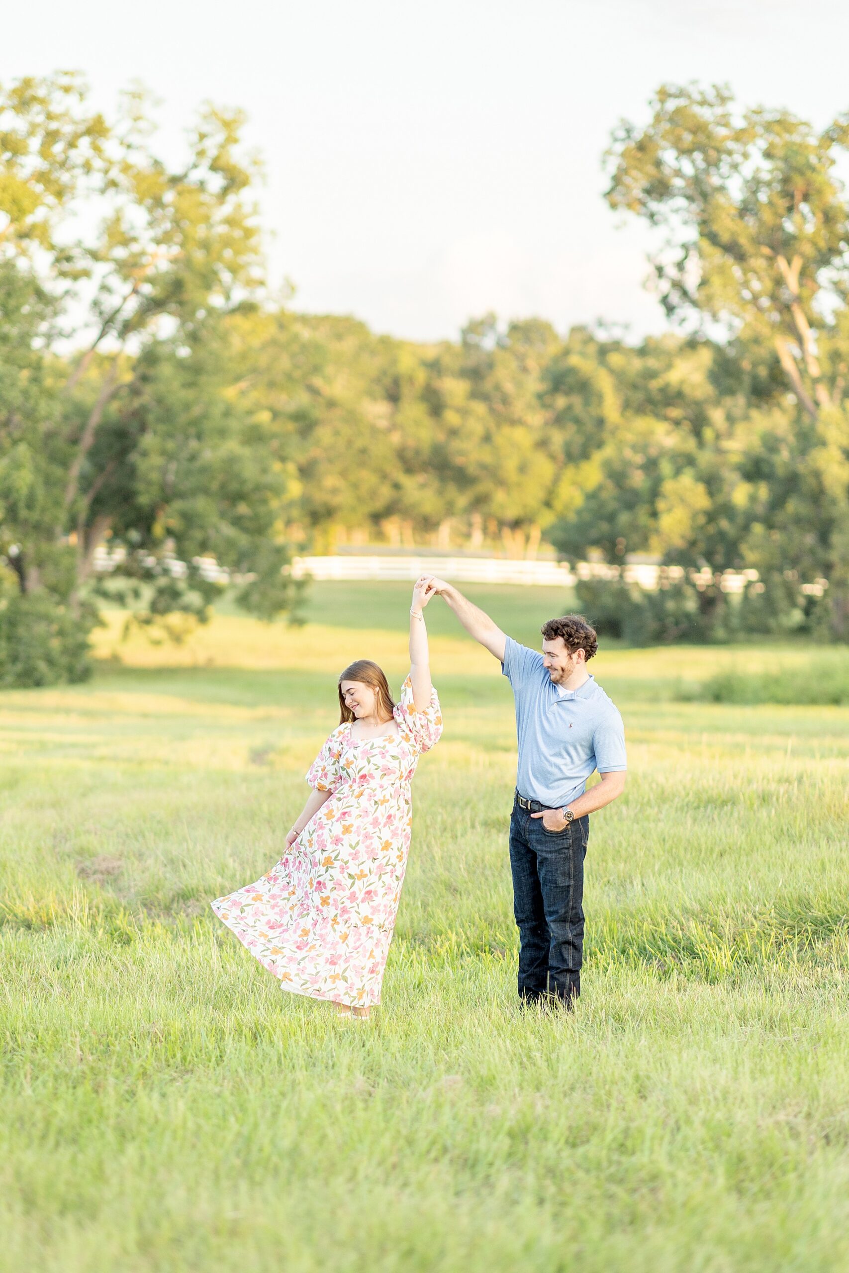 candid portraits of couple dancing in field 