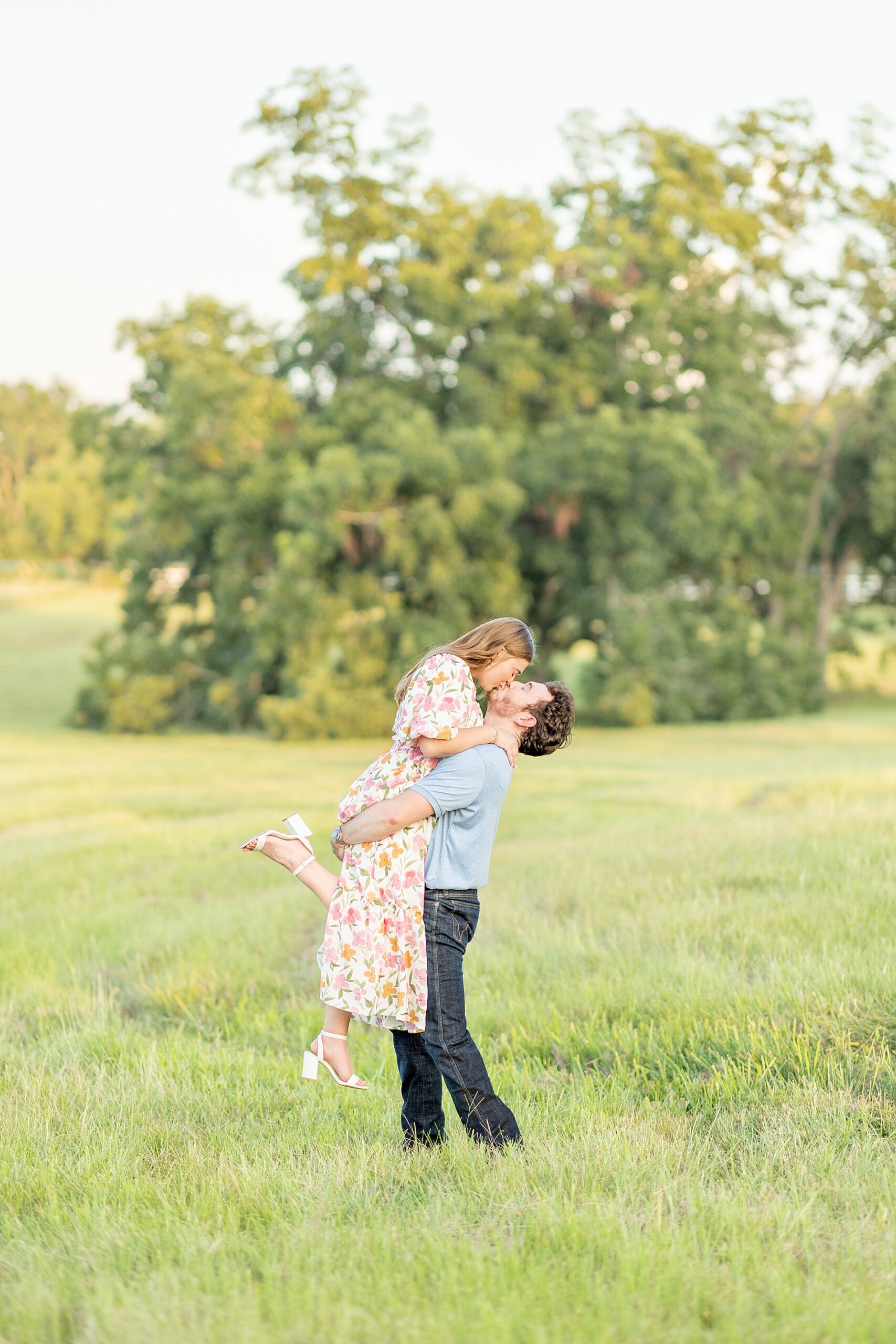 Deep In The Heart Farms Engagement engagement portraits of man lifting and kissing his fiancé 