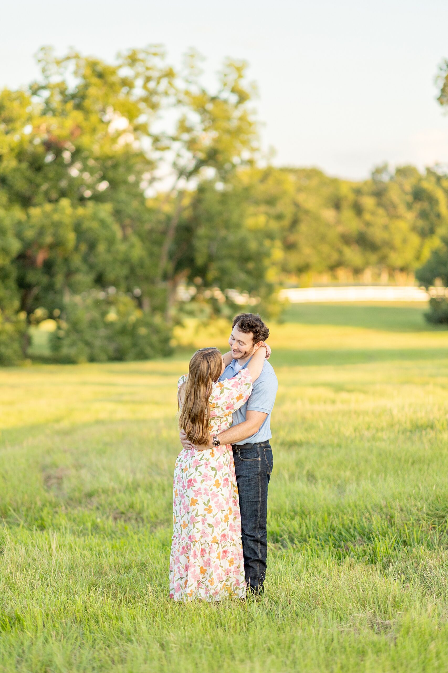 couple look at each other as they hug 