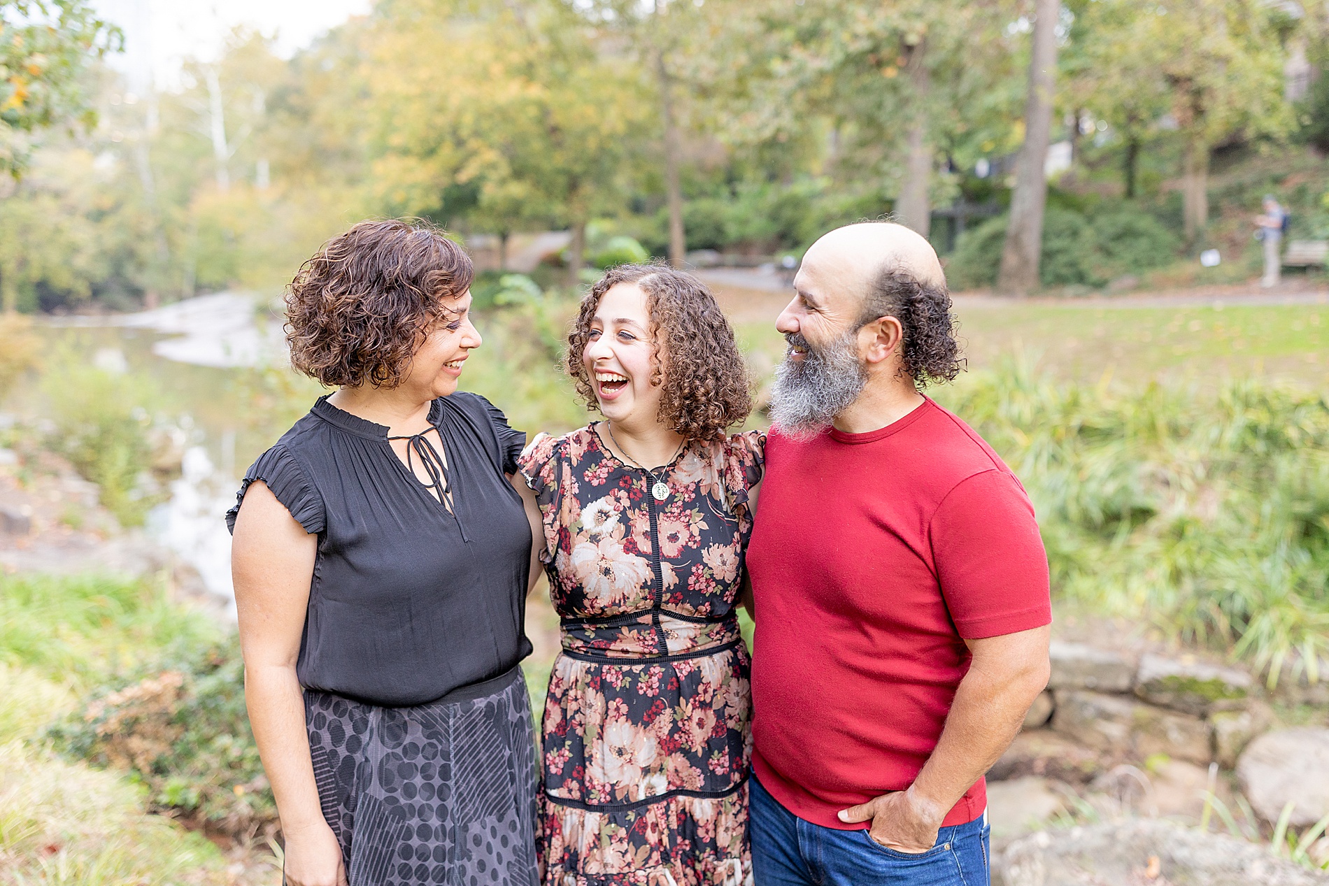 parents stand with daughter for graduation photos