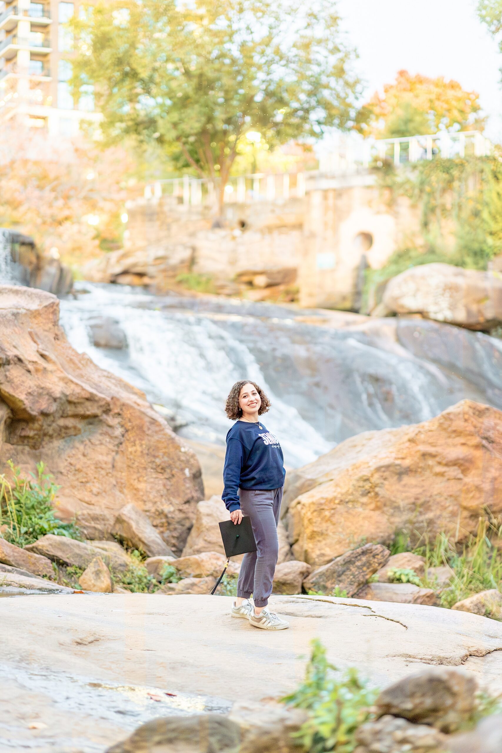 senior portraits by waterfall at Falls Park