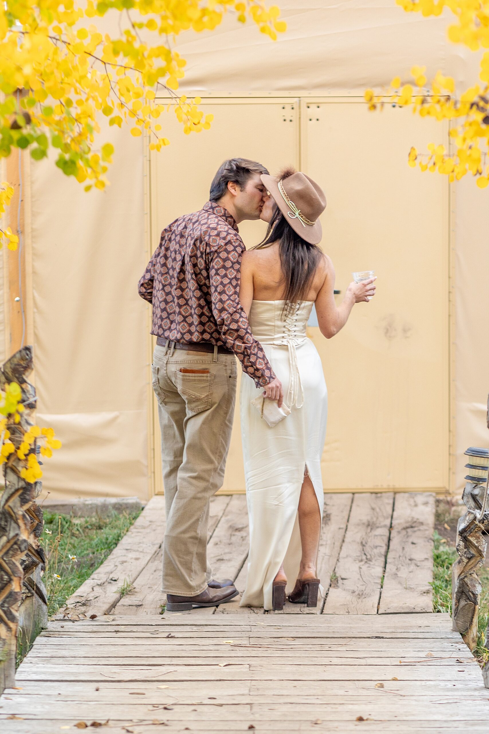 couple kiss before wedding welcome party | Colorado Wedding at Beyul Retreat