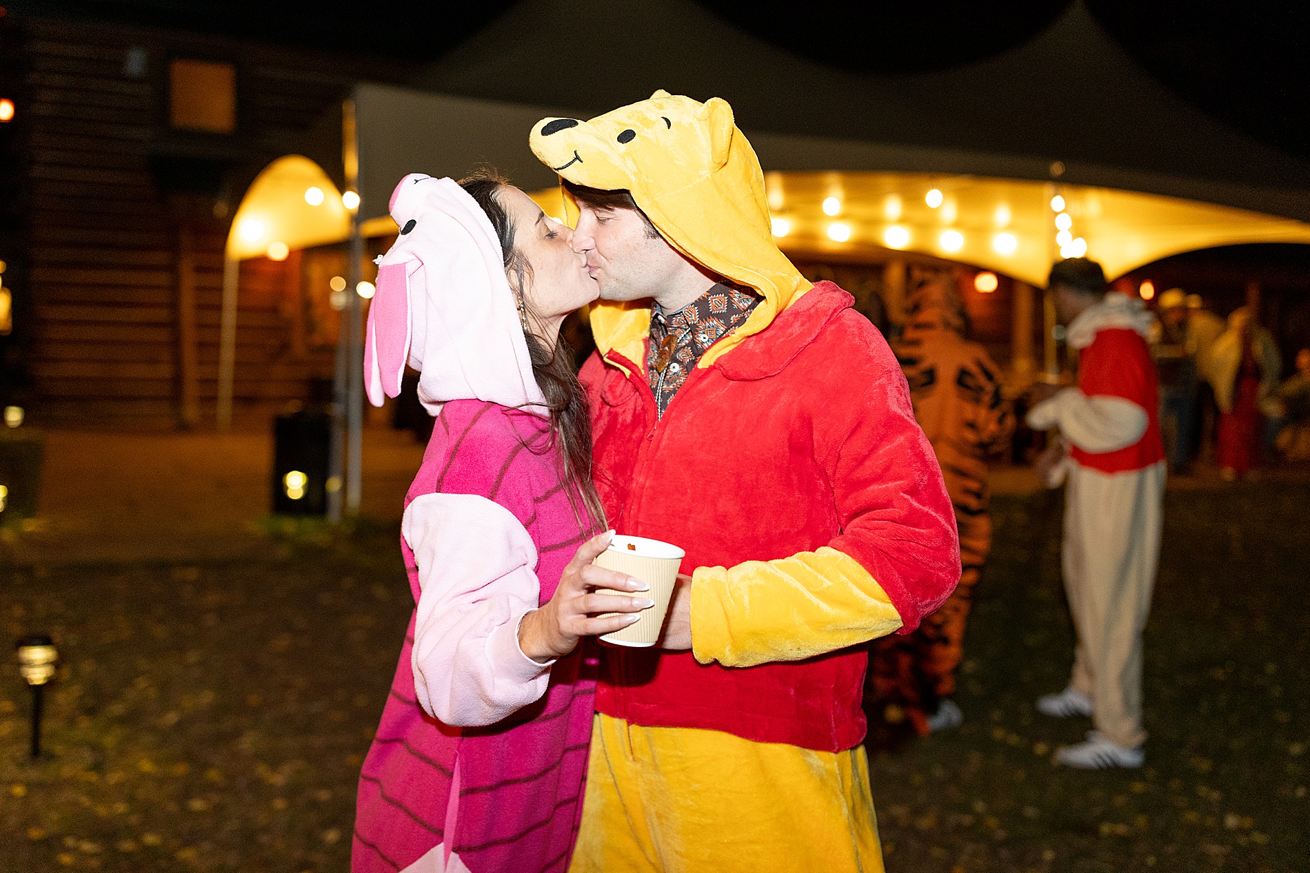 couple kiss at wedding welcome paper