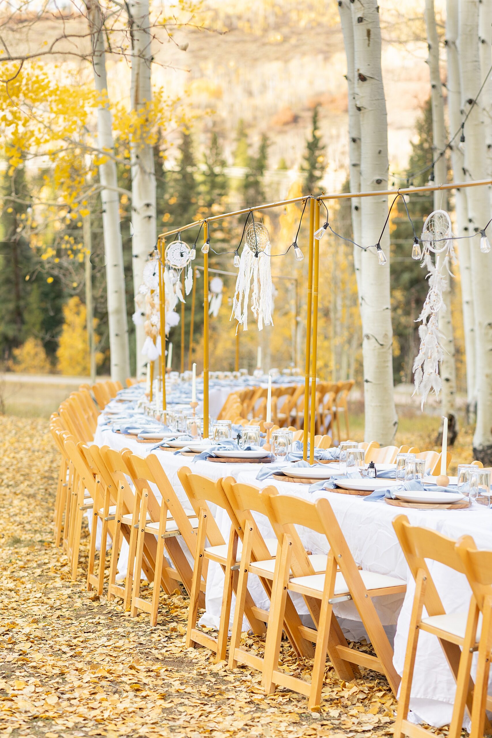 tables set up outdoors for wedding welcome dinner | Colorado Wedding at Beyul Retreat