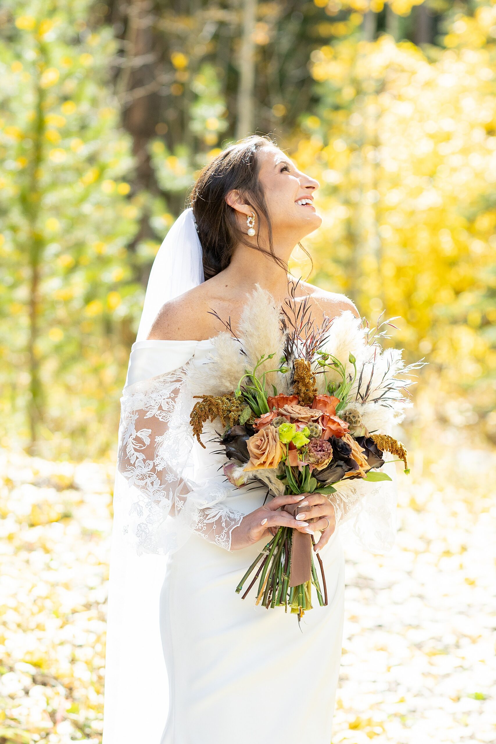 bride holding whimsical, rustic wedding bouquet