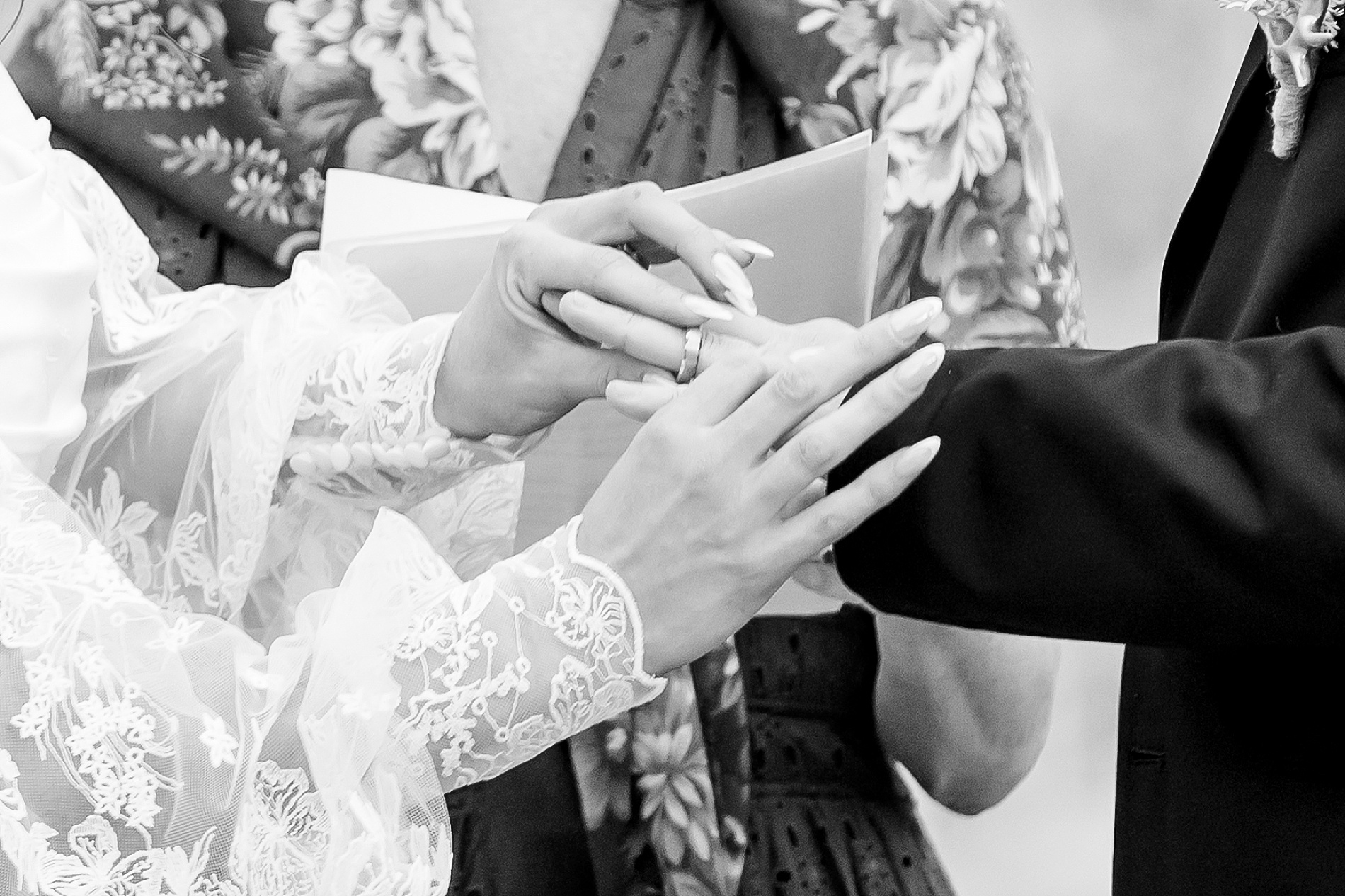 bride putting ring on groom's finger