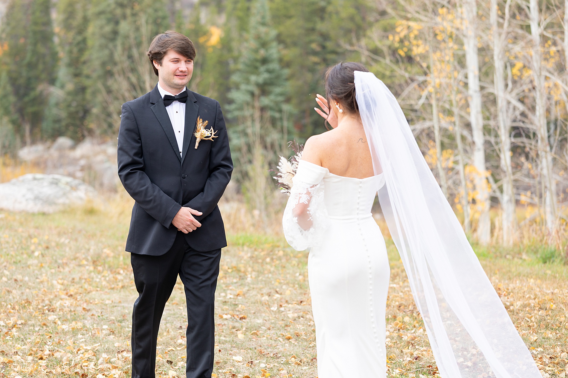 candid first look photos from Colorado Wedding at Beyul Retreat