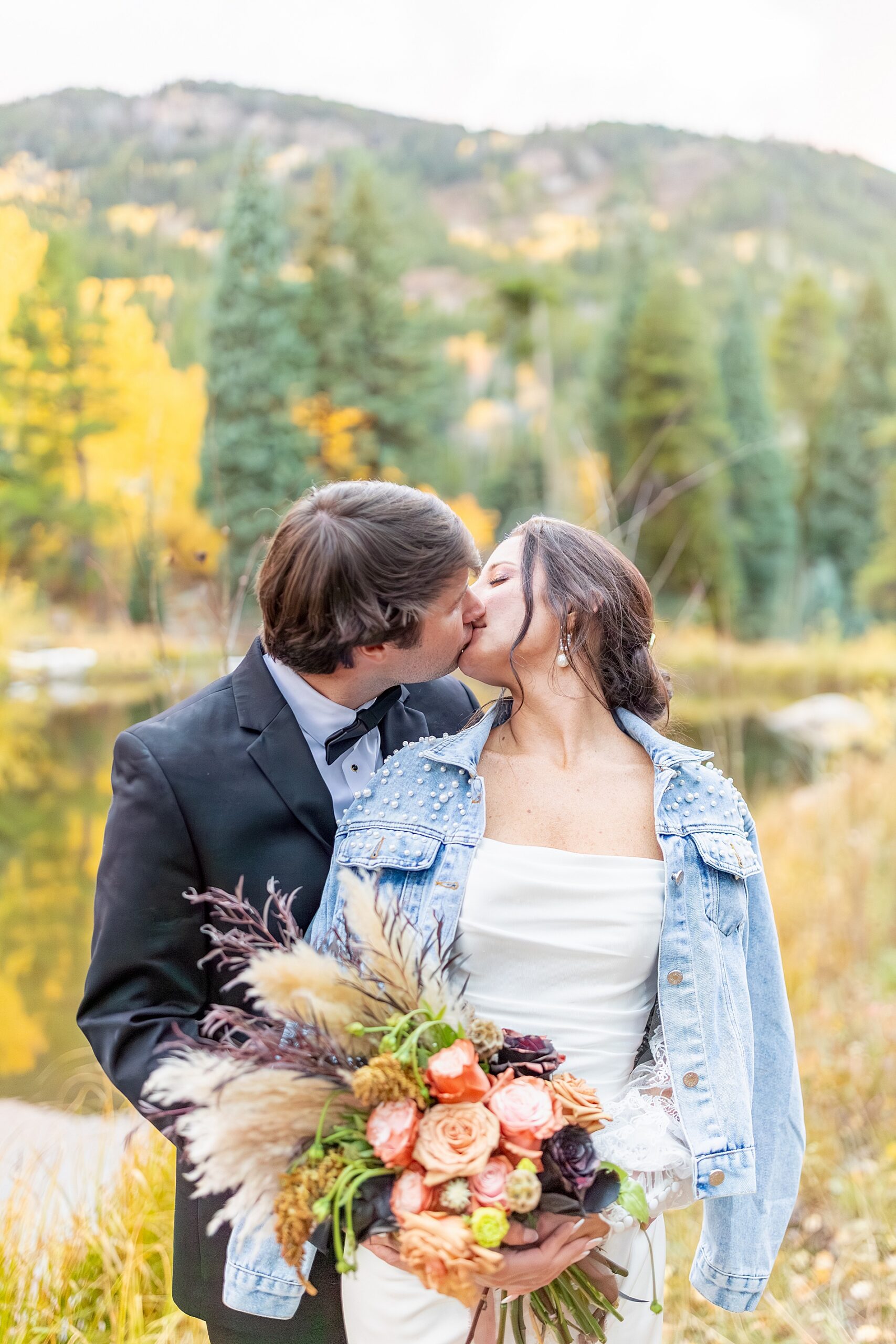 newlyweds kiss from fall wedding