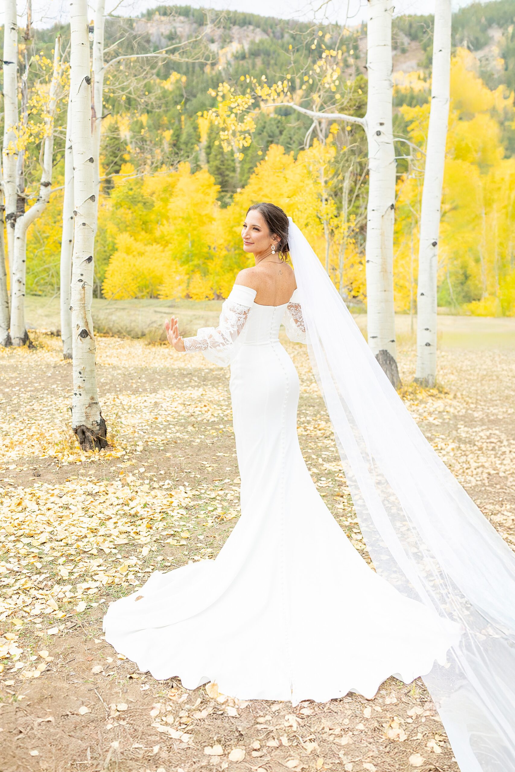 bride in wedding dress with it fanned out | Colorado Wedding at Beyul Retreat