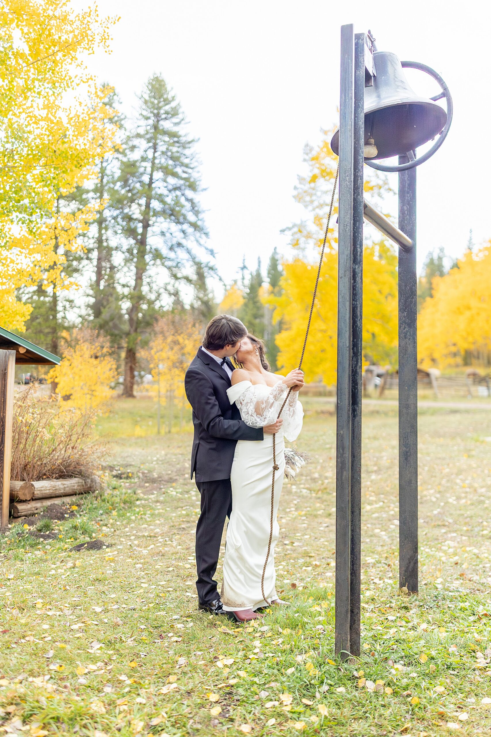 couple kiss as they ring bell