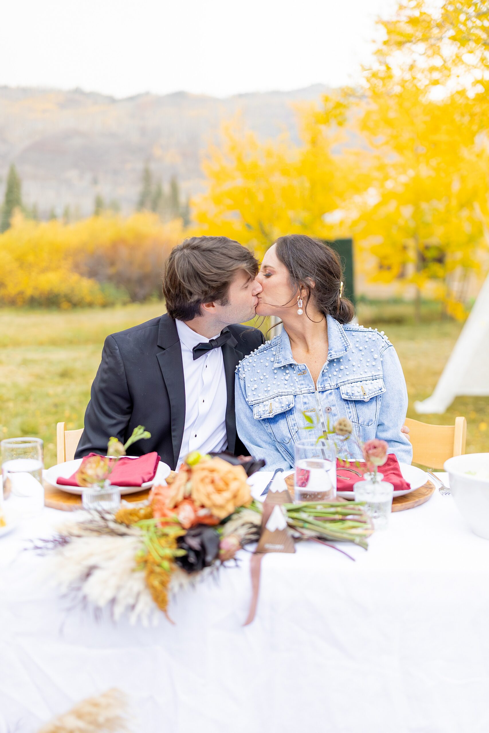 couple kiss at fall wedding in Aspen, Colorado at Beyul Retreat