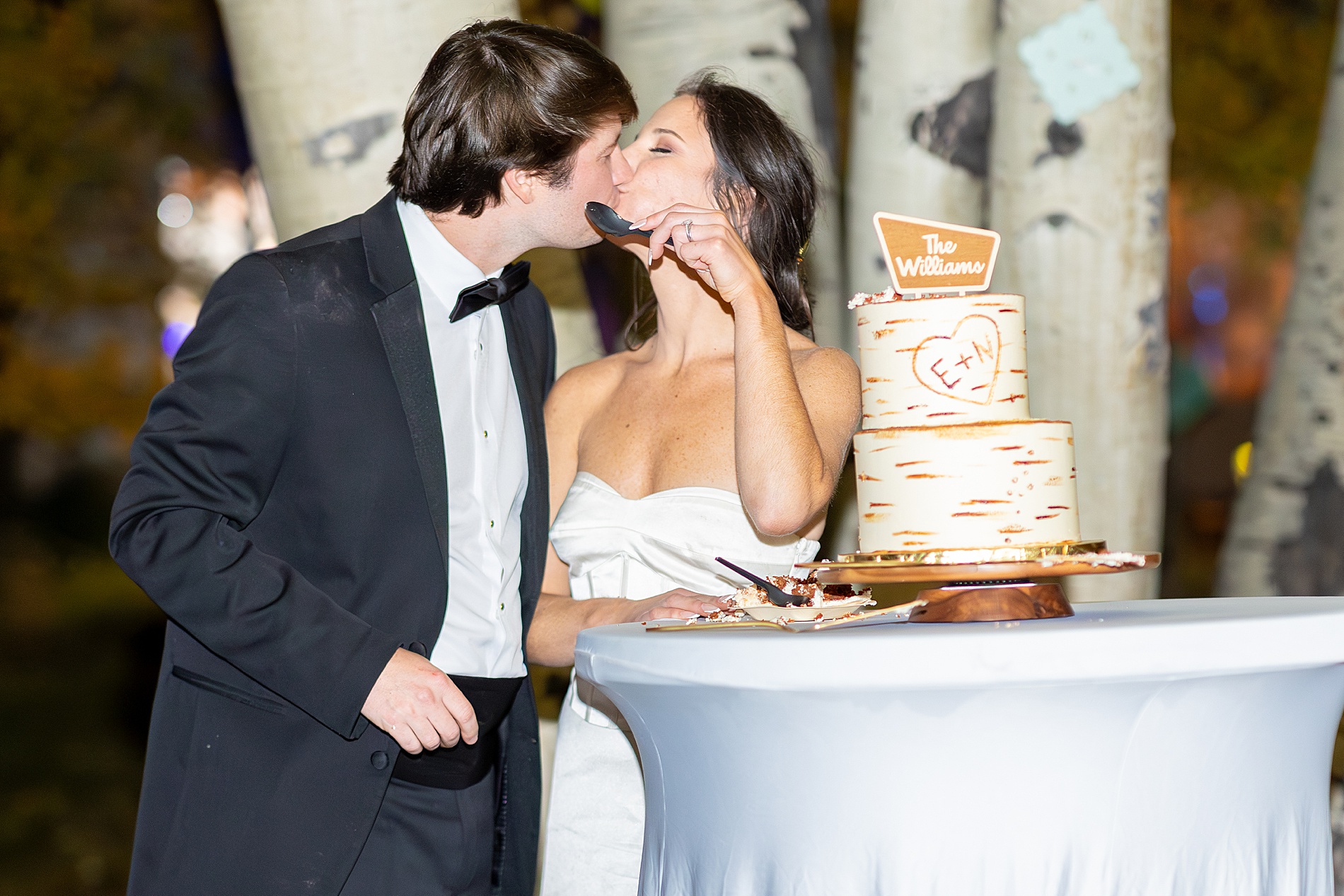 newlyweds eat wedding cake