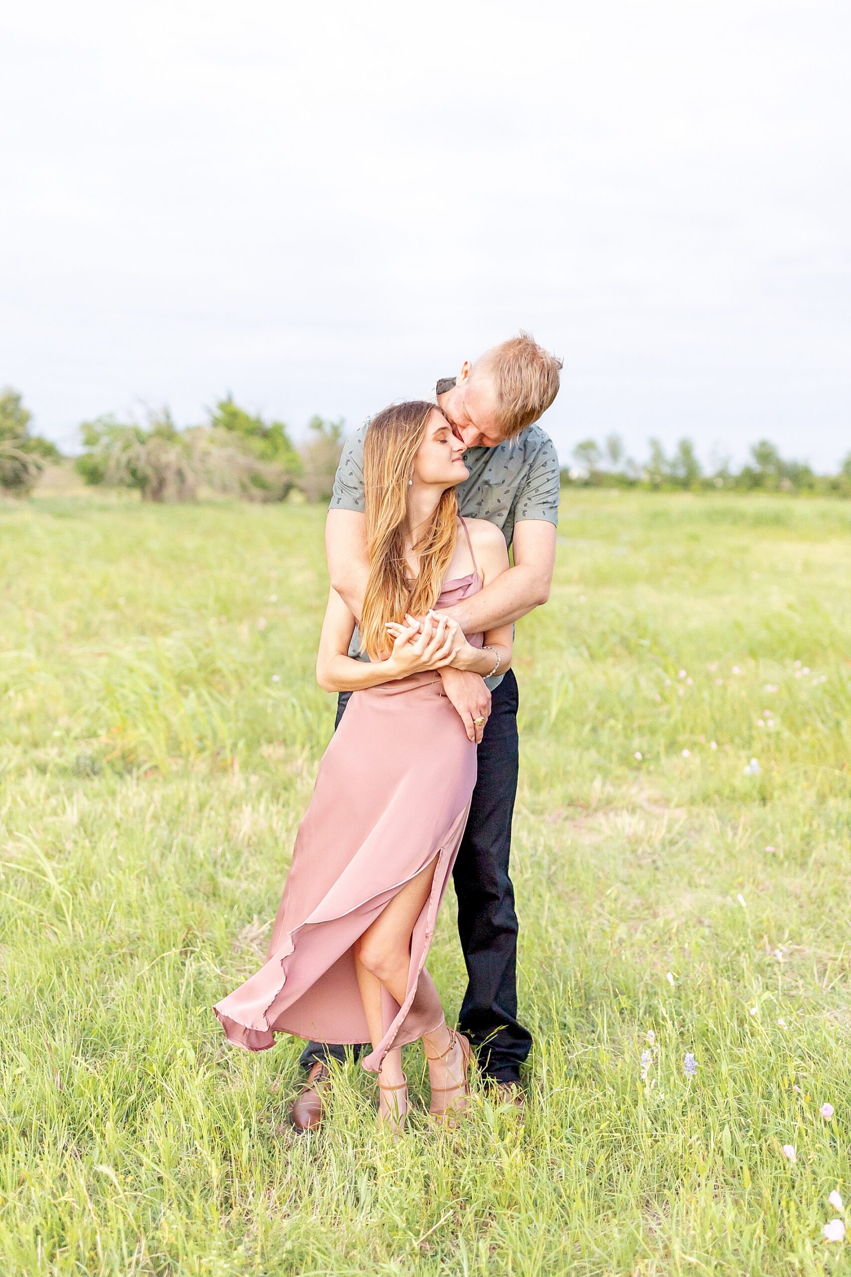 man wraps his arms around fiancé