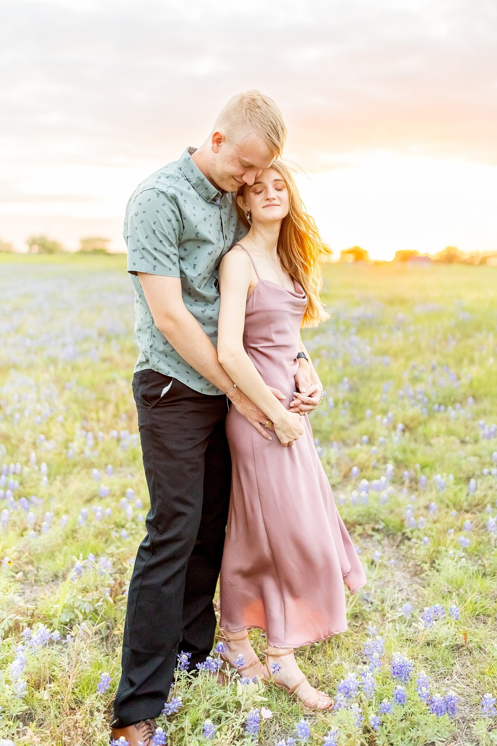 Romantic engagement session in field of bluebonnets by Houston wedding photographer