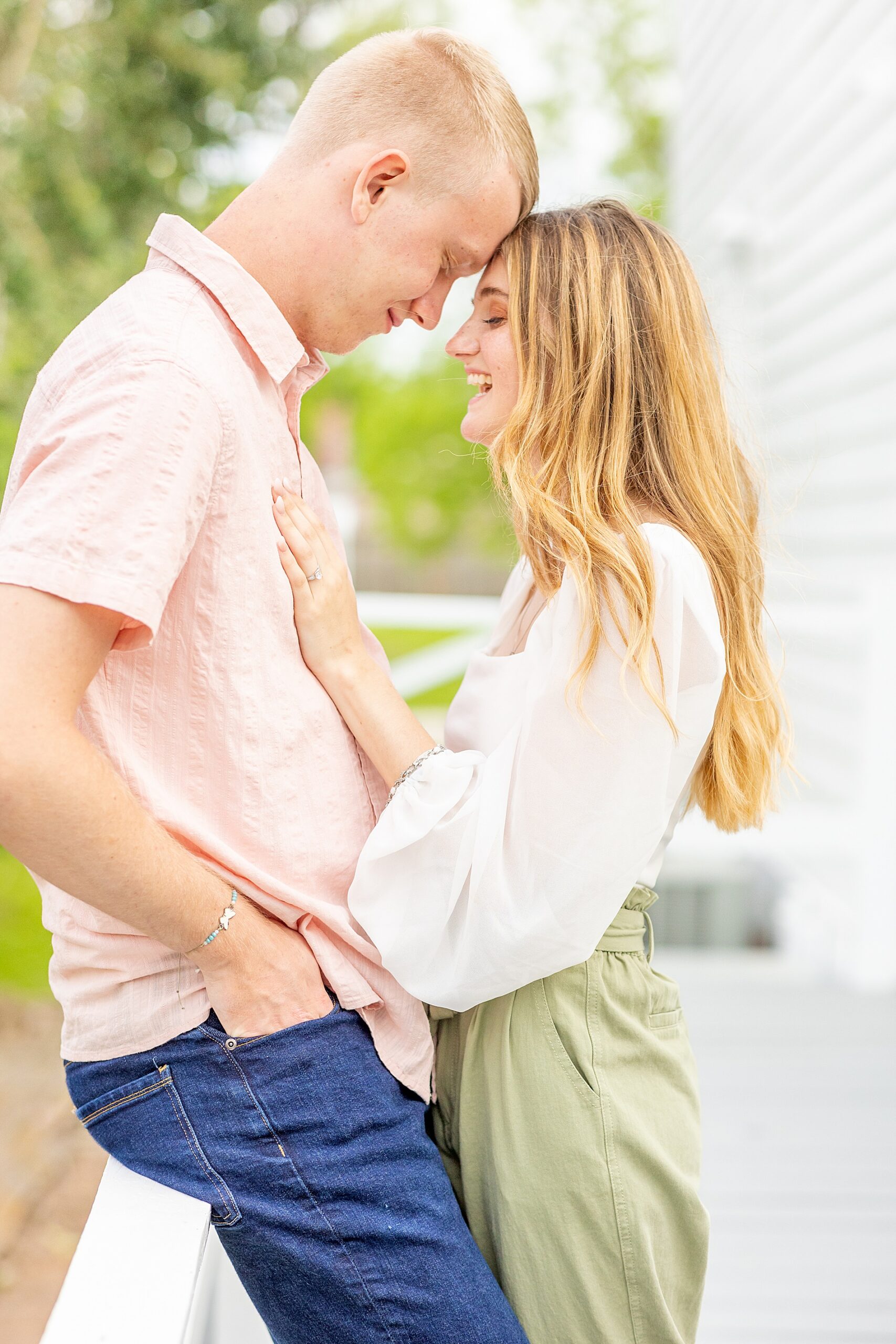engaged couple lean in together