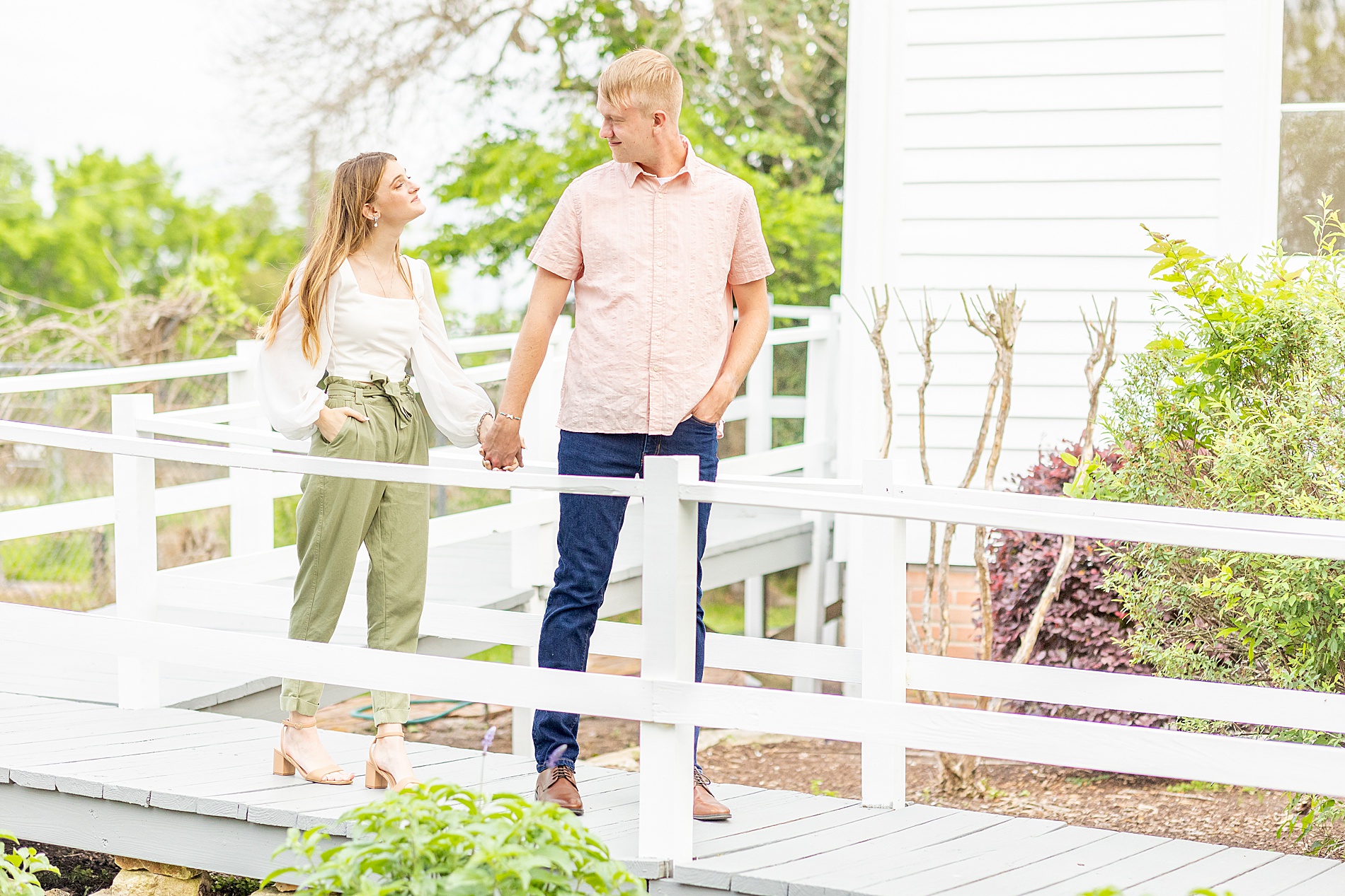 engaged couple walk down ramp from church