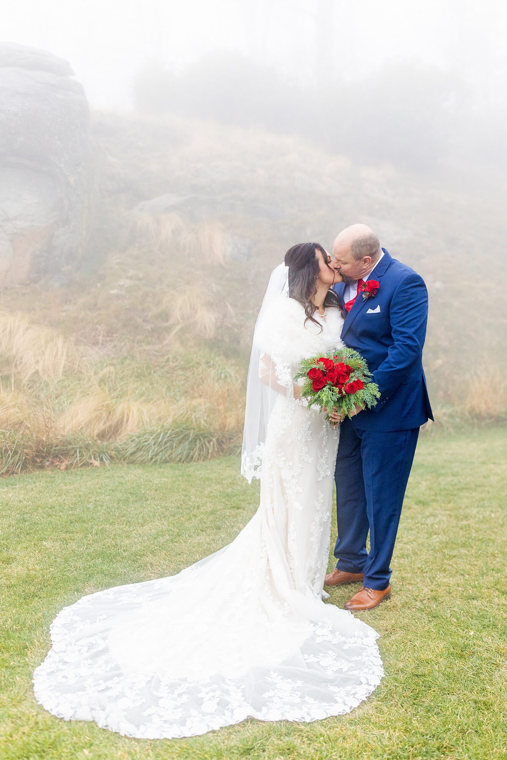 newlyweds kiss on hillside