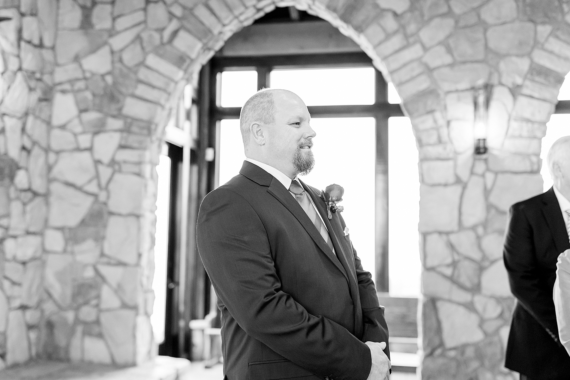 groom watches bride walk down the aisle 