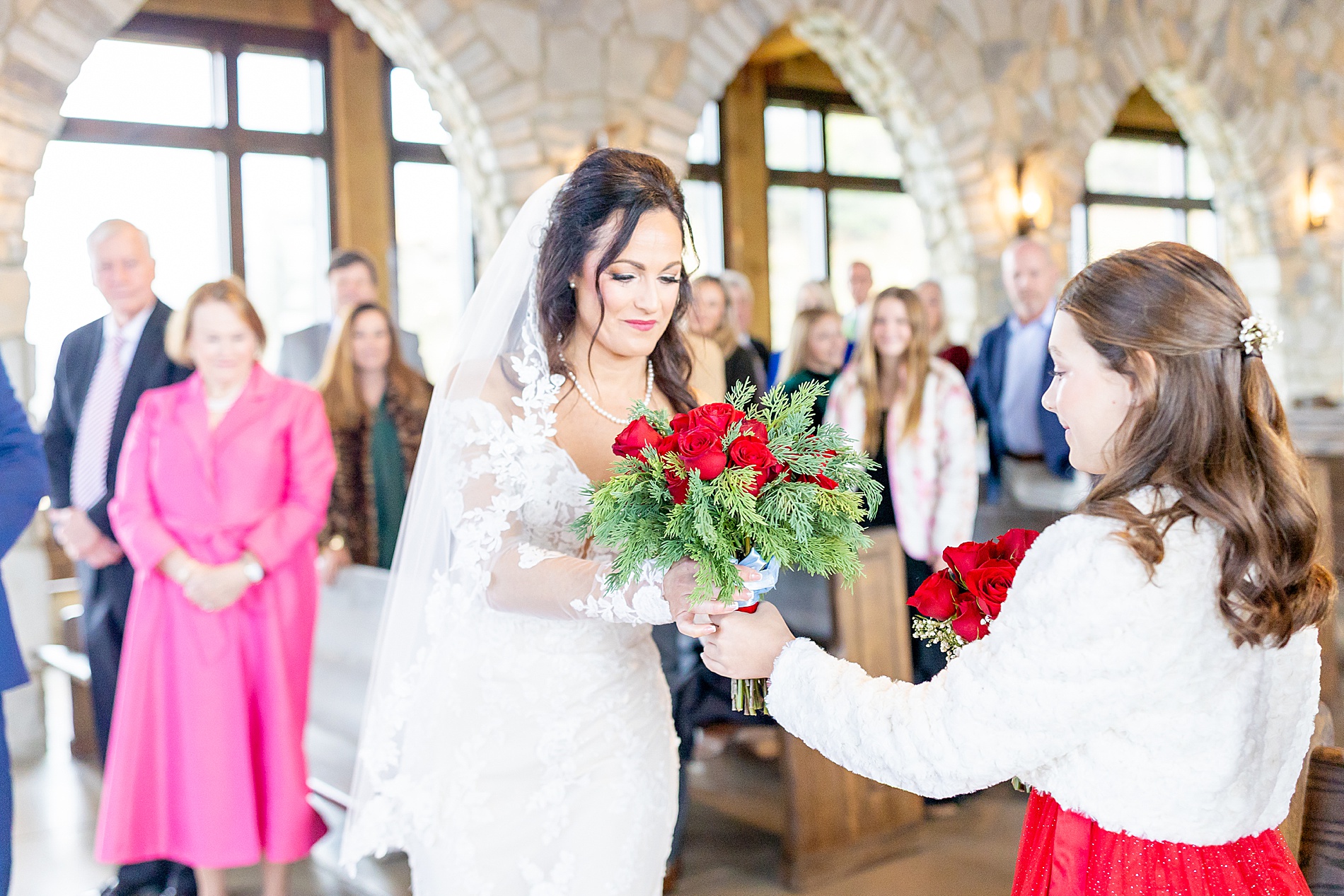 bride hands flowers to daughter
