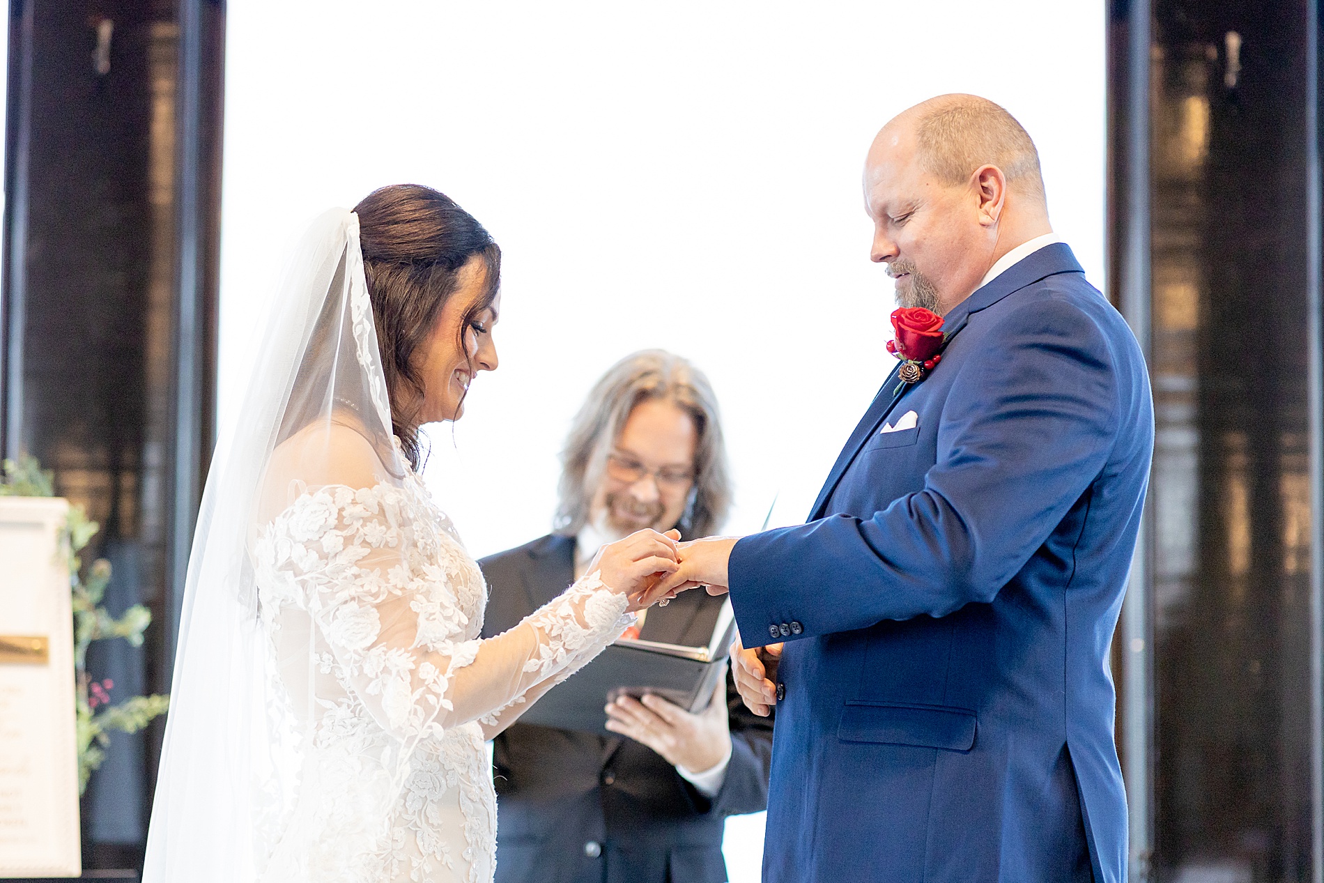 bride and groom exchange wedding rings