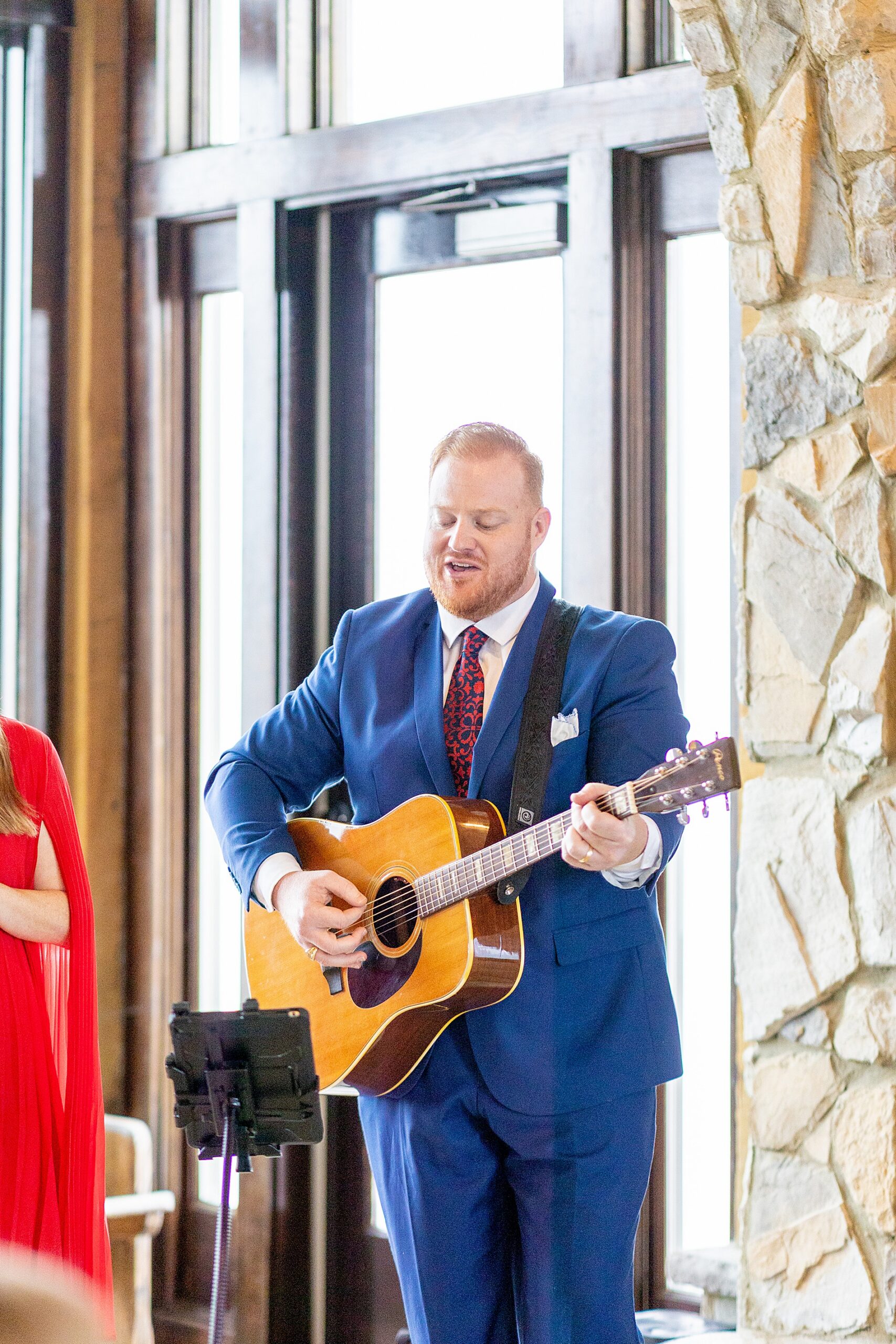 man playing guitar at wedding ceremony 
