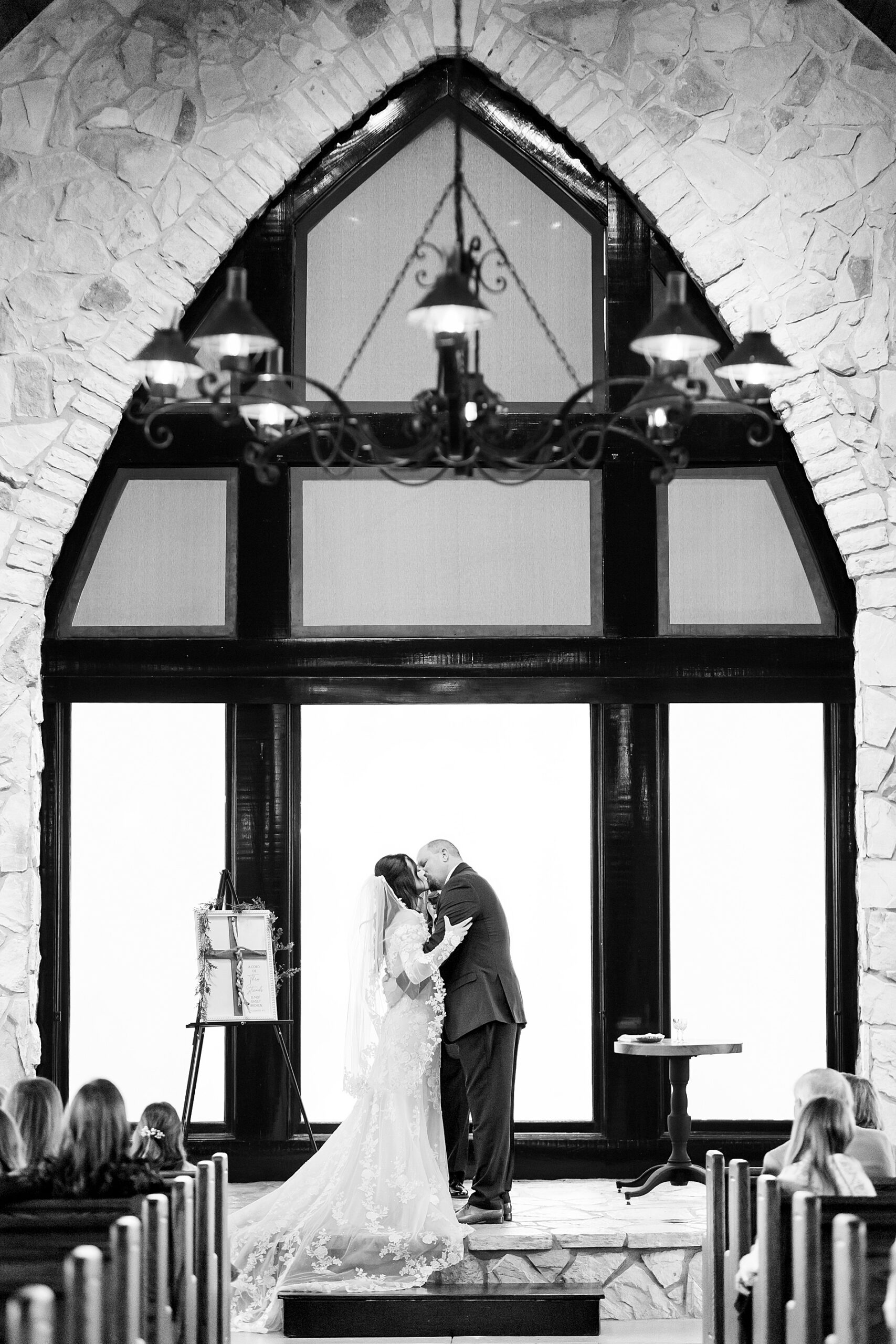 bride and groom kiss at ceremony