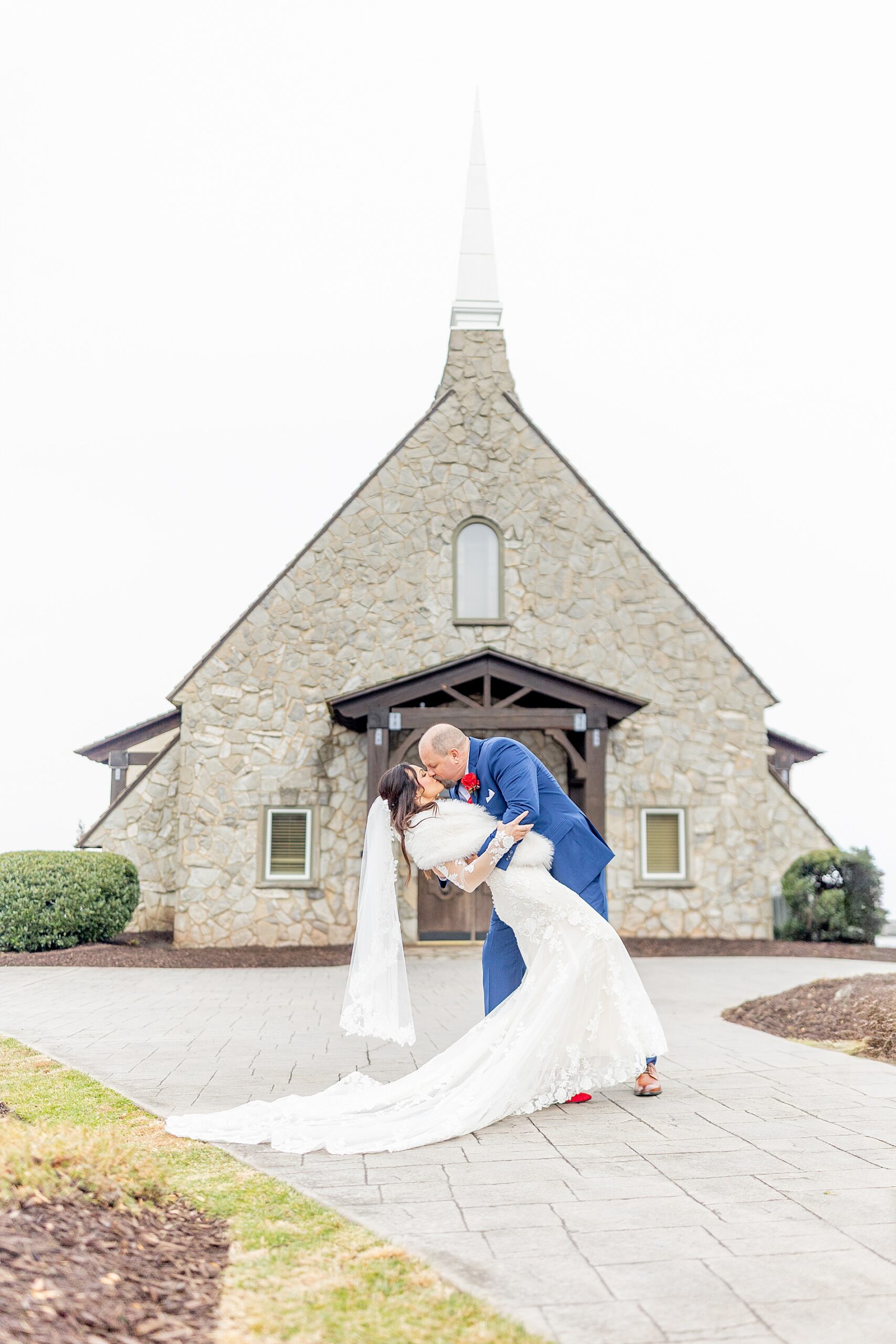 groom dips bride outside of chapel
