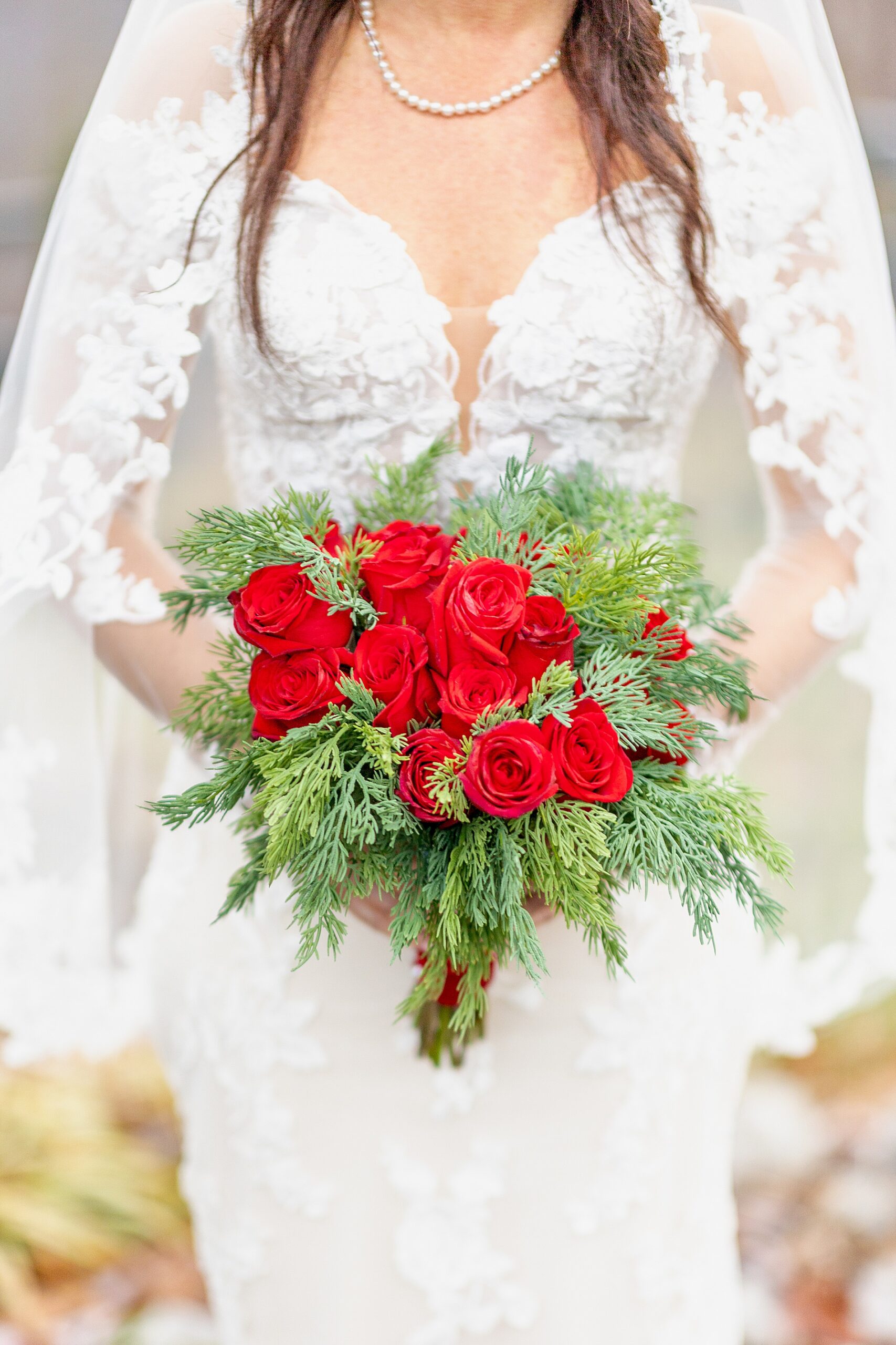 bride in wedding dress holding festive Winter wedding bouquet 