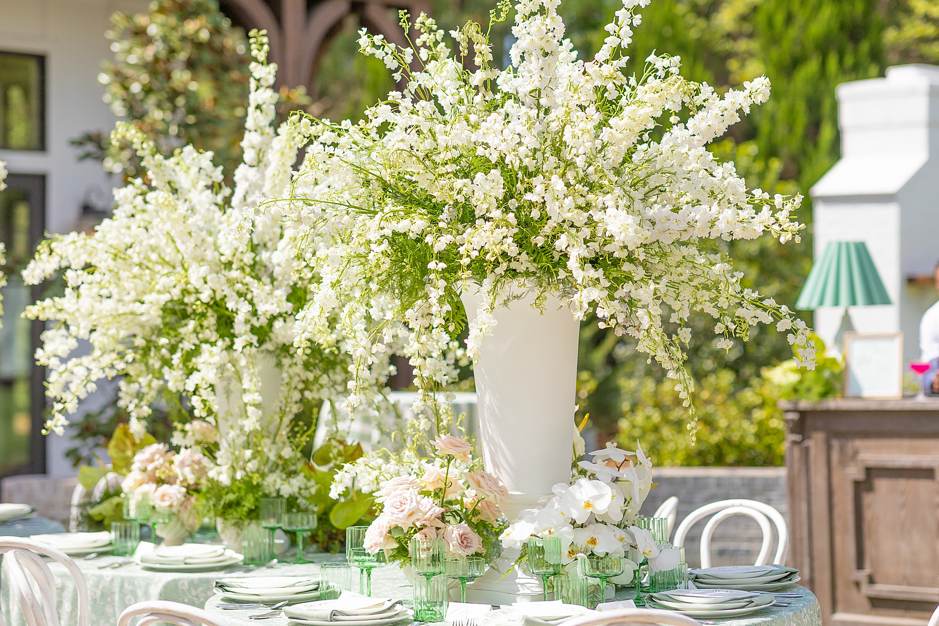 tall, full floral arrangements decorate the center of tables