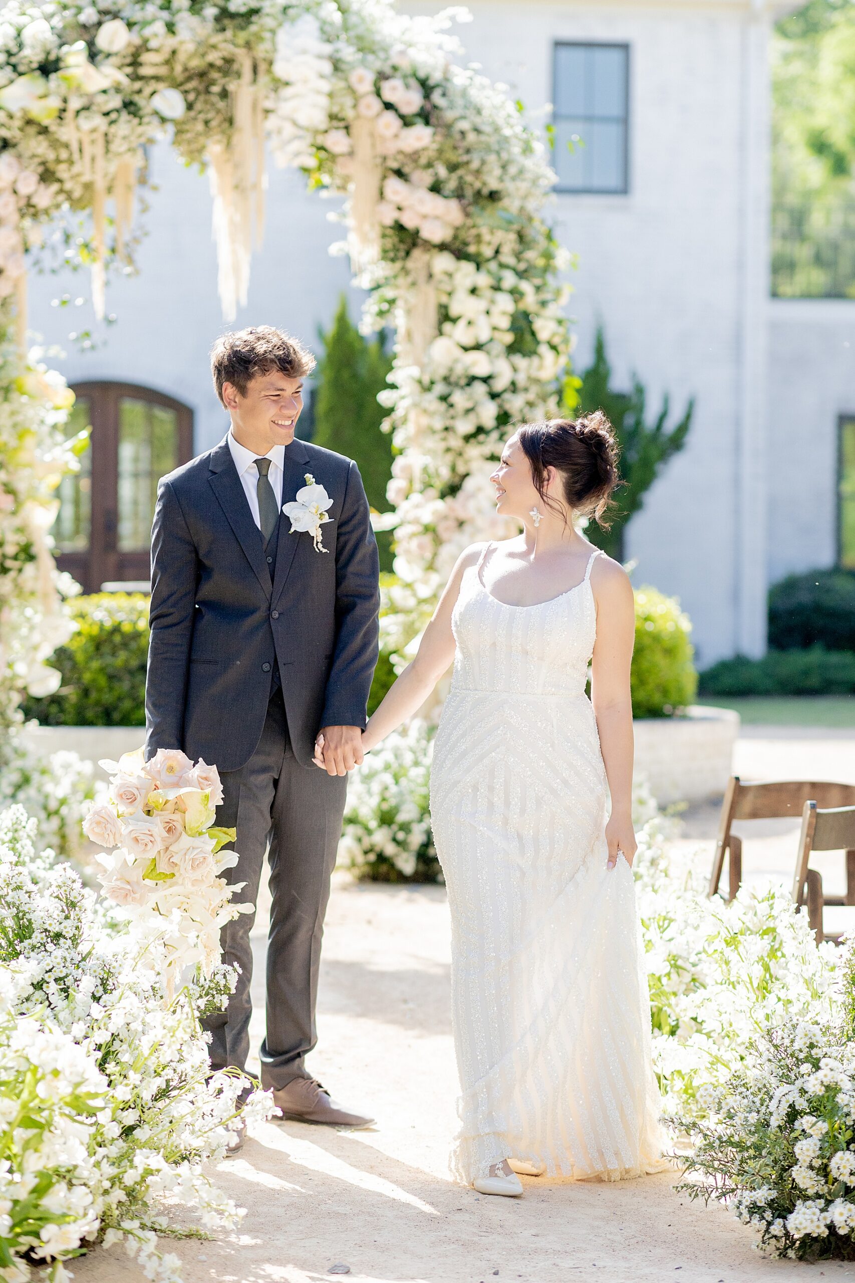 bride and groom hold hands 