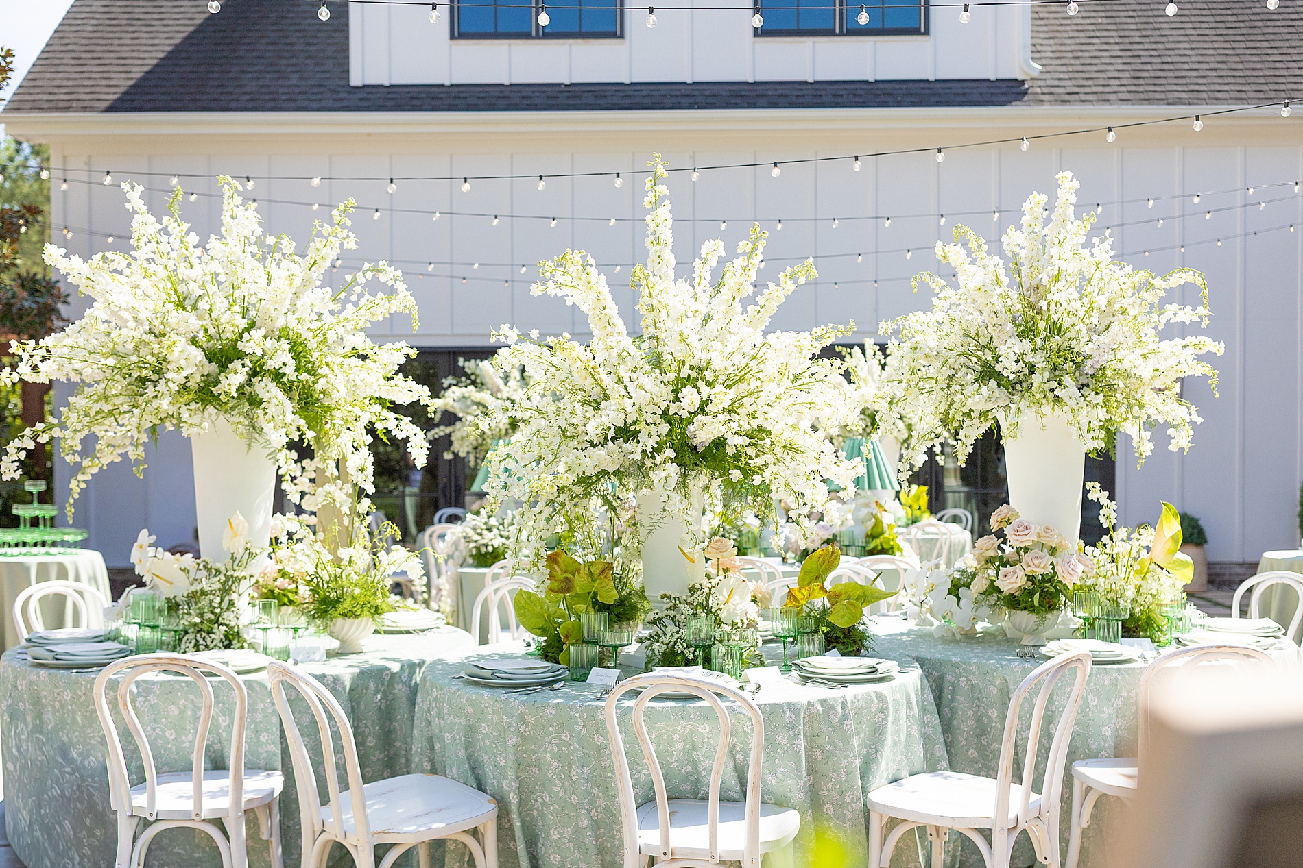 lush floral centerpieces decorate outdoor reception 