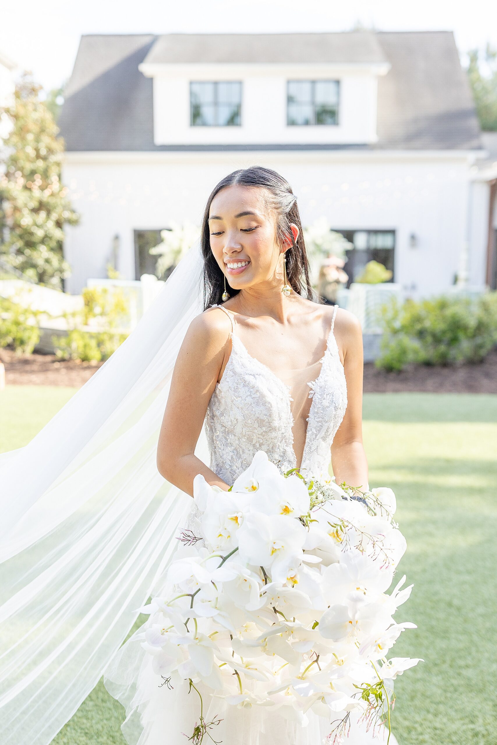 bridal portraits outside of The Bradford holding white lily bouquet 