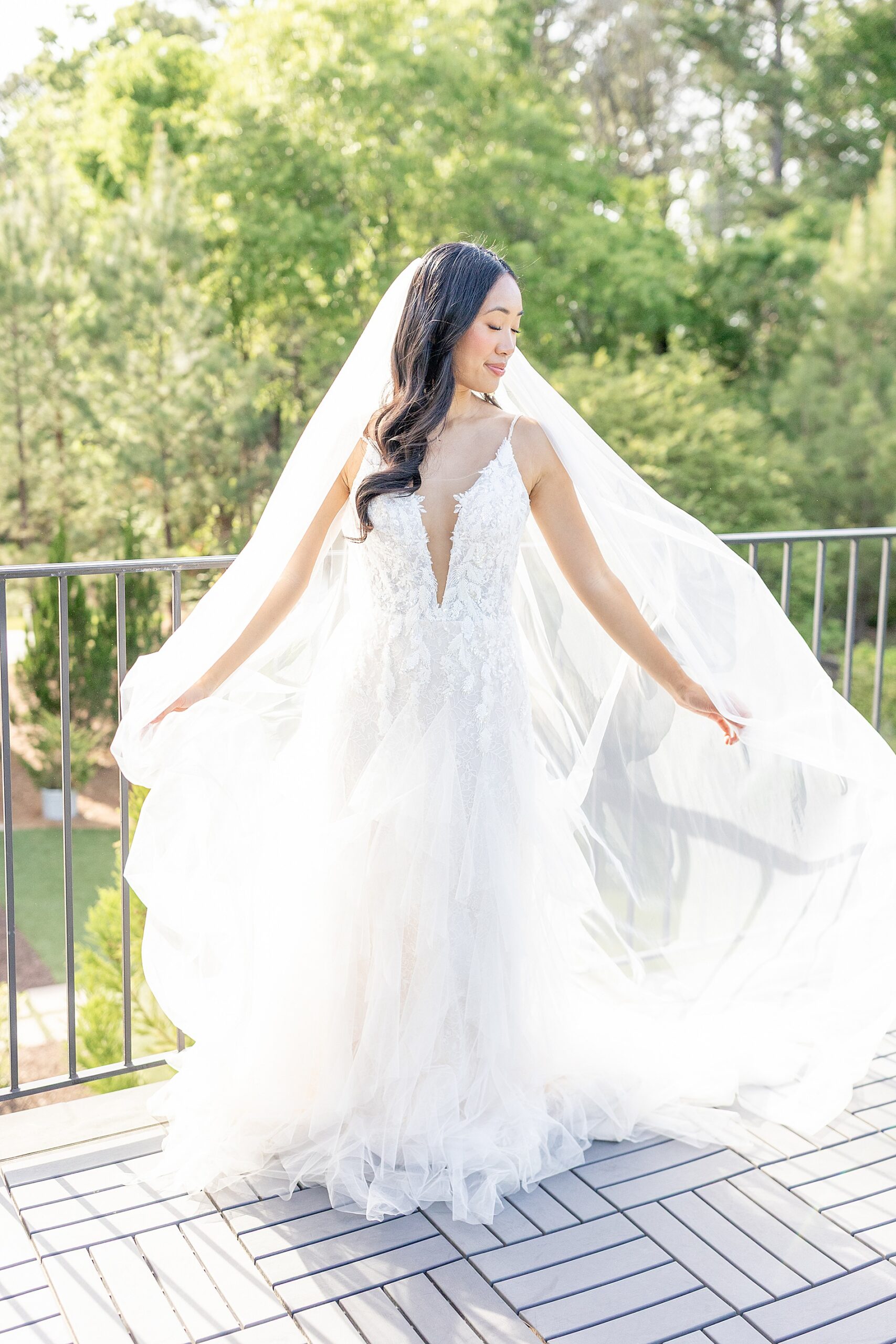 bride walking with veil fanned out behind her 
