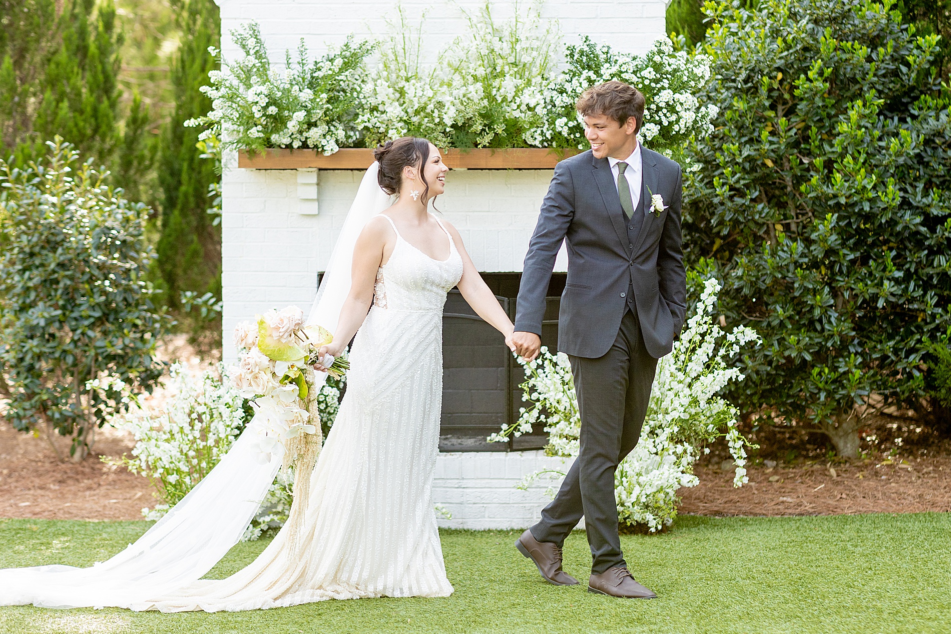 bride and groom walking together holding hands 
